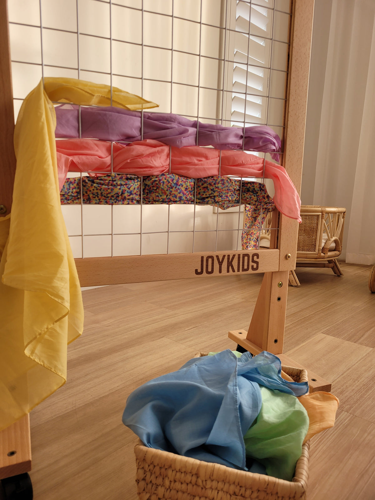 Wheeled wooden art display rack for hanging children's artwork and posters