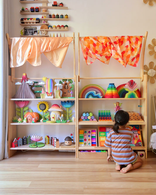 Convertible play station with front-facing bookshelf, white magnetic board and acrylic boards