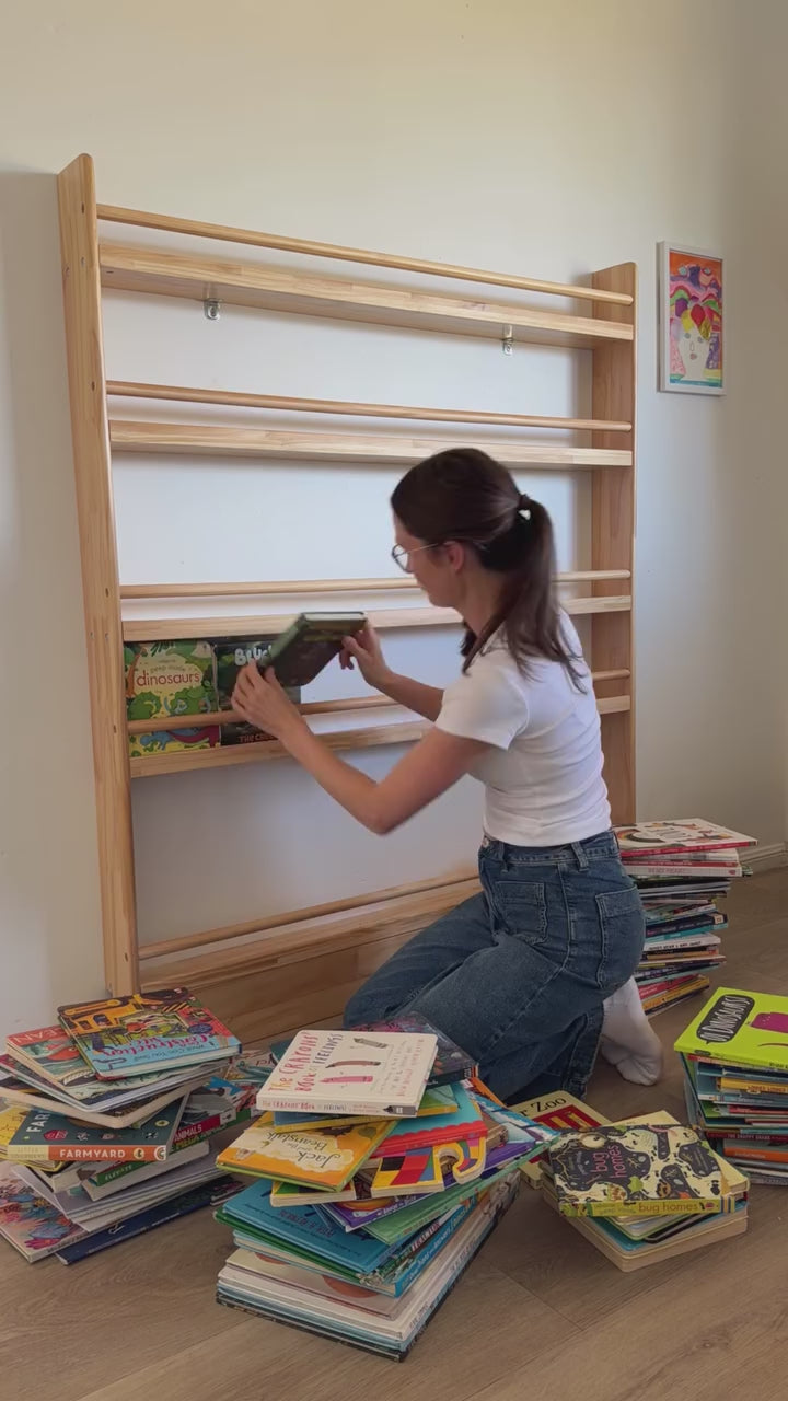 A JORY 5 front-facing bookshelf being filled, showing how many children's books it holds