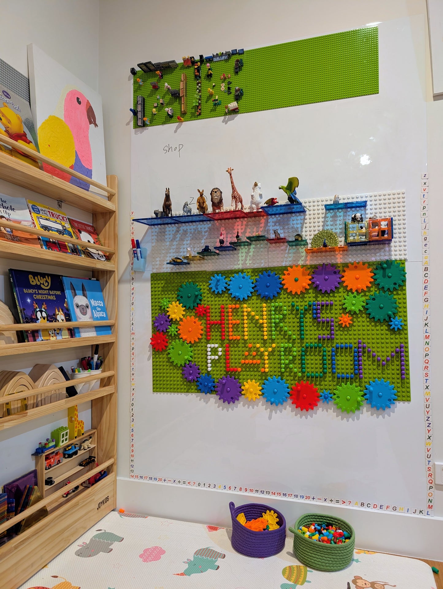 Wooden-board peg-and-gear kinetic construction kit for cause-and-effect learning