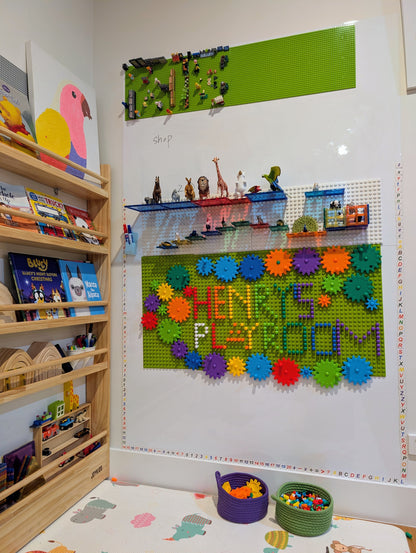 Wooden-board peg-and-gear kinetic construction kit for cause-and-effect learning